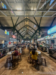 people sitting at tables in a food court