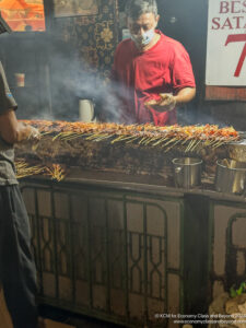 a man cooking food on a grill