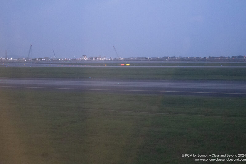 a runway with lights in the distance