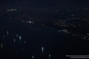 a city at night with lights on the water