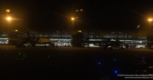 a plane at night in a terminal