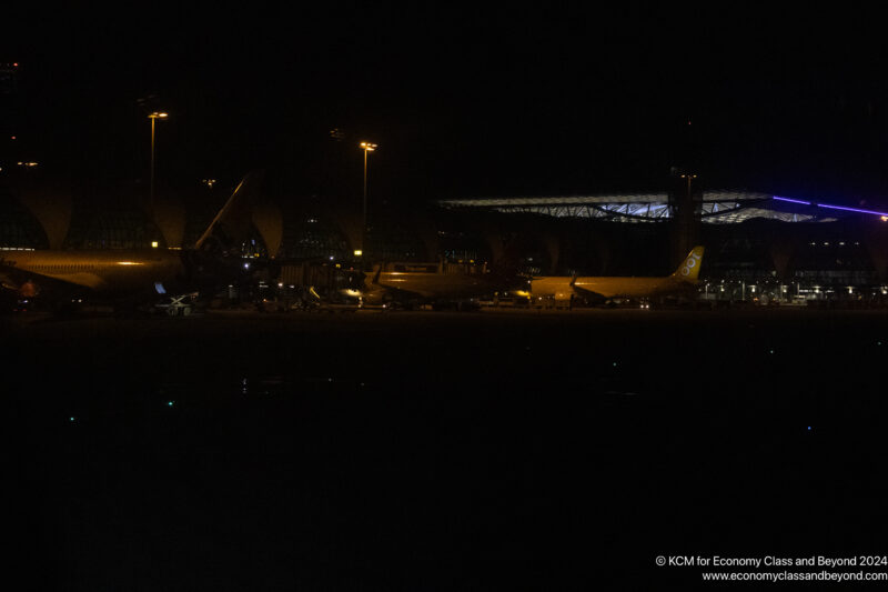 a plane parked at night