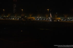 airplanes at night in an airport