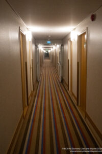 a hallway with a striped carpet