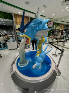 a statue of a dragon drinking water
