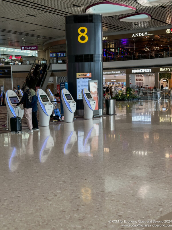 people standing in a large airport terminal