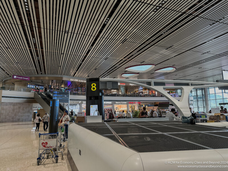 a large airport with people walking around