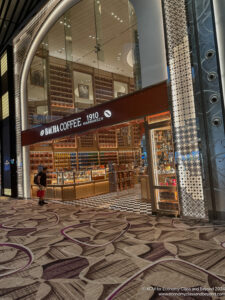 a storefront with a woman walking in front of it