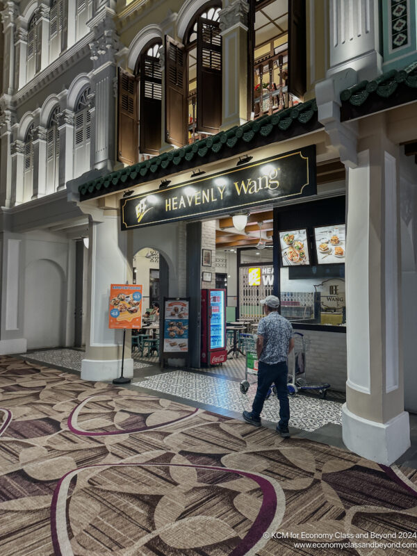 a man standing in front of a restaurant