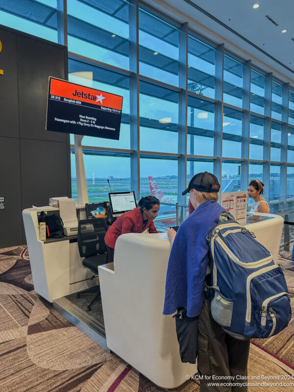 people at a desk in a airport