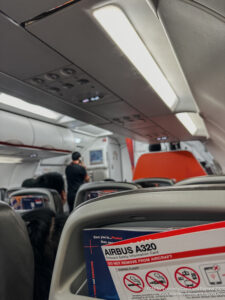an airplane with seats and people in the background