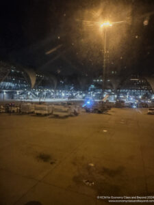 a large airport with lights and cars