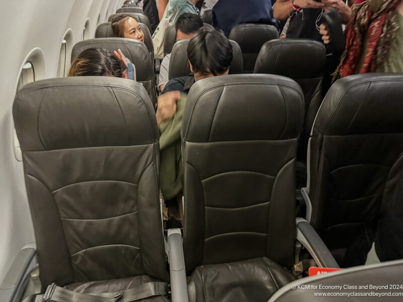 a group of people sitting in an airplane