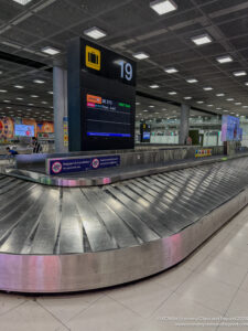 a baggage claim area with a sign