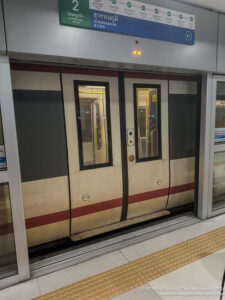 a train doors with a sign