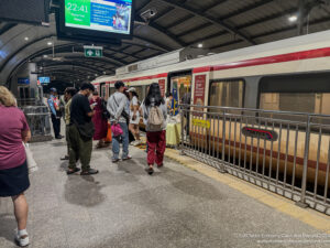 a group of people standing in a train station