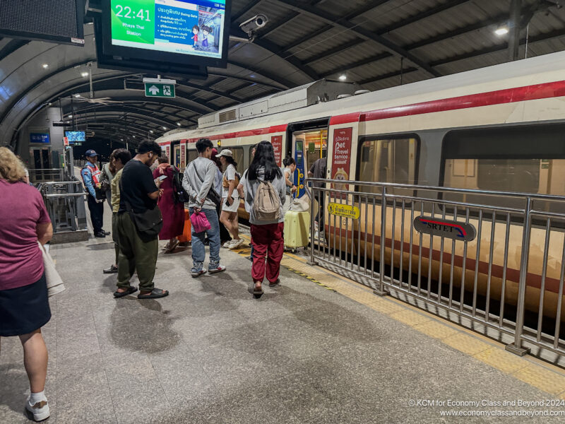 a group of people standing in a train station