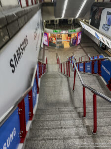 a staircase with red railings and blue railings