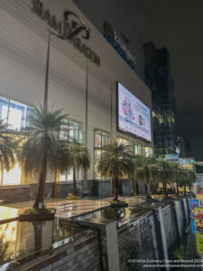 a building with palm trees and a sign