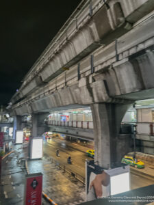 a city street with a bridge over it