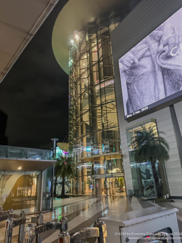 a building with glass walls and a large screen