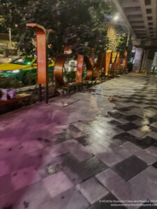 a sidewalk with a sign on it