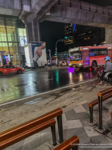 a bus and a car on a wet street