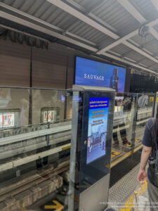 a person standing next to a screen