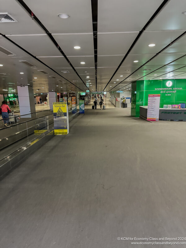 a walkway with luggage in an airport