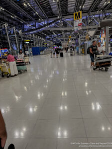 people in an airport with people walking and luggage