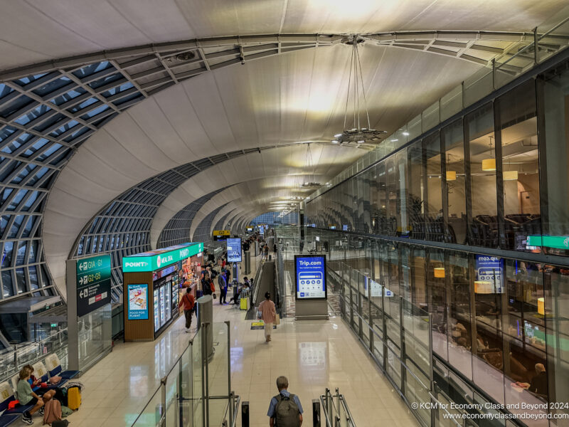 a group of people walking in a large airport