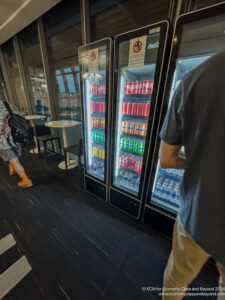 a group of people standing next to a cooler