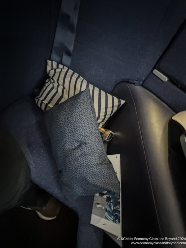 a pillow and a book on a seat in a car