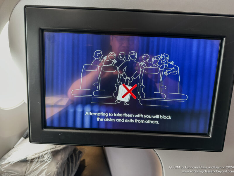 a screen with a picture of people sitting in chairs