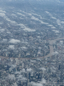 aerial view of a city with a river and buildings