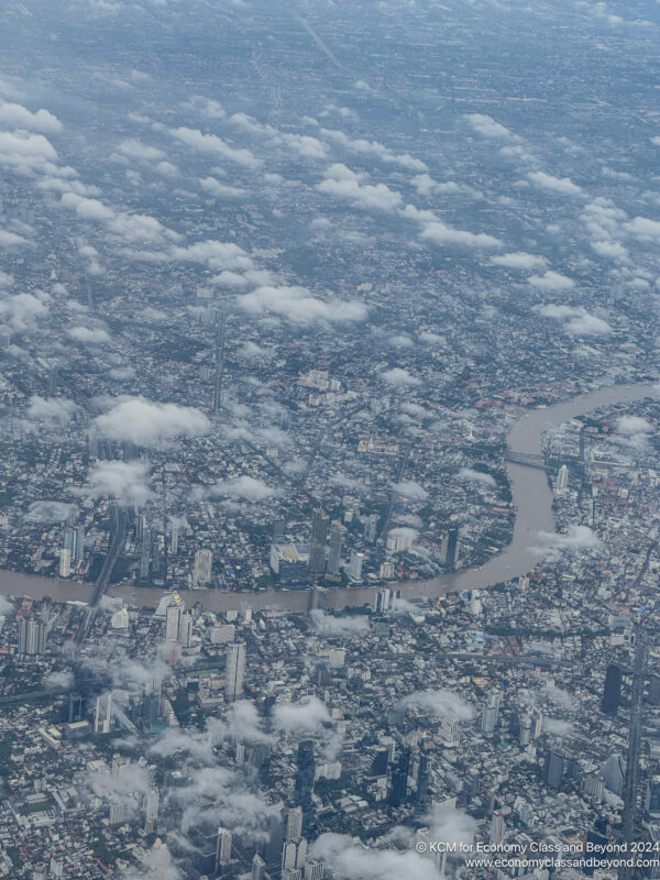 aerial view of a city with a river and buildings