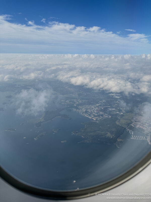 aerial view of a city and water from an airplane window