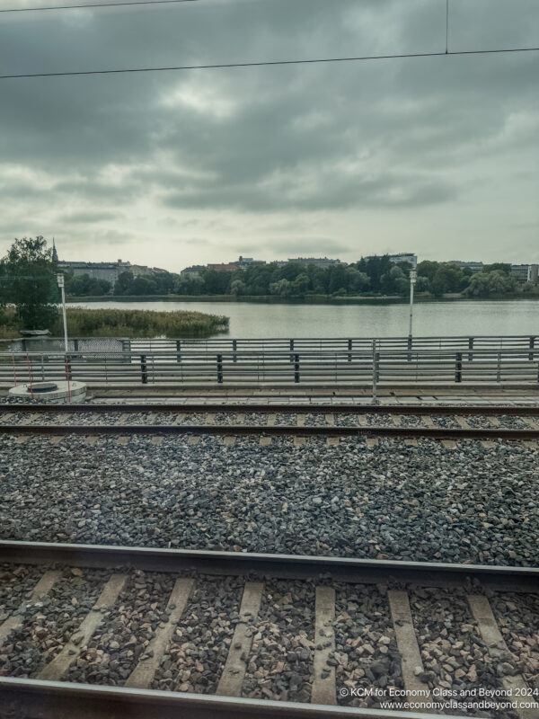 train tracks next to a body of water