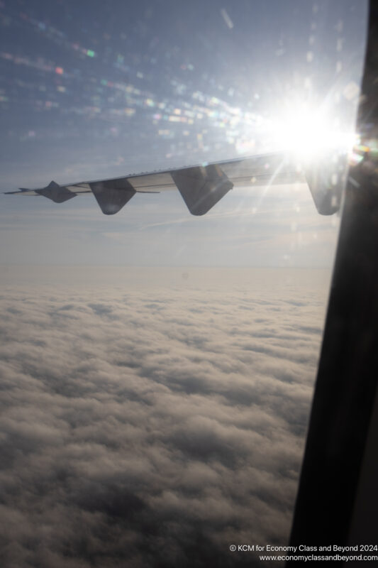 the wing of an airplane above the clouds