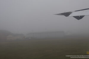 a plane flying in the fog