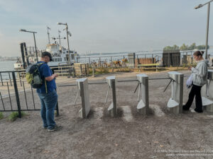 a man standing in front of a row of metal objects