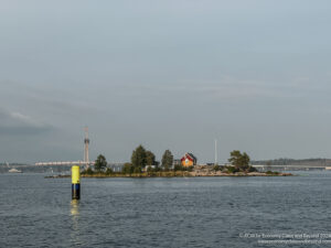 a body of water with a yellow pole in the middle of it