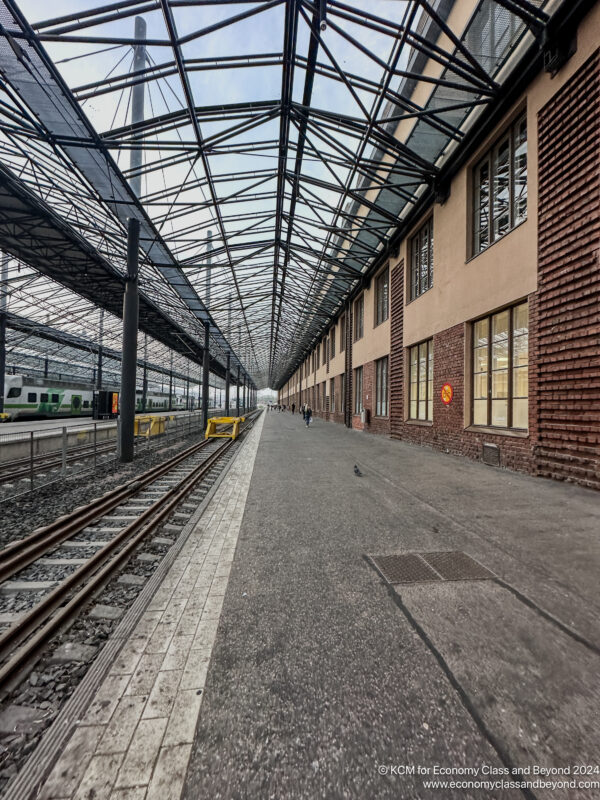 a train tracks next to a building