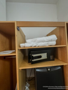 a microwave and towels on a shelf