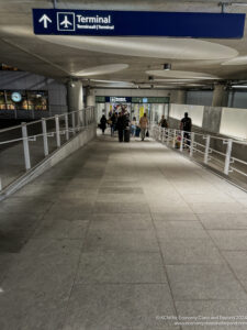 a walkway with people walking in a building