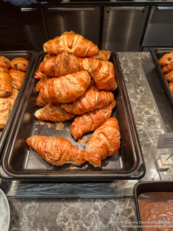 a trays of croissants on a counter