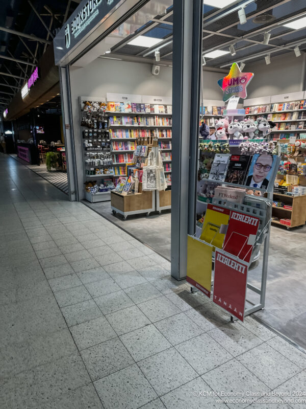 a store with shelves of books and a sign