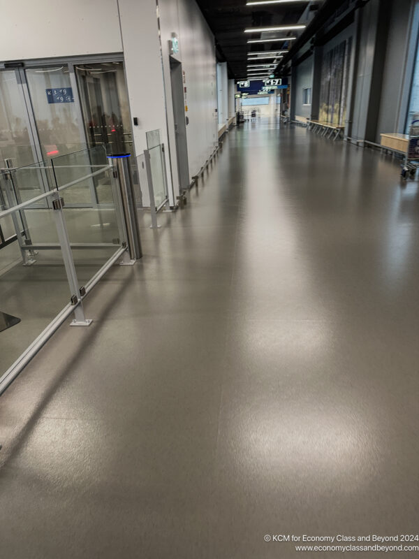 a hallway with glass doors and a railing