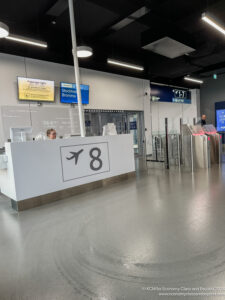 a man standing behind a counter in a airport