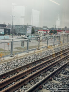 train tracks next to a fence